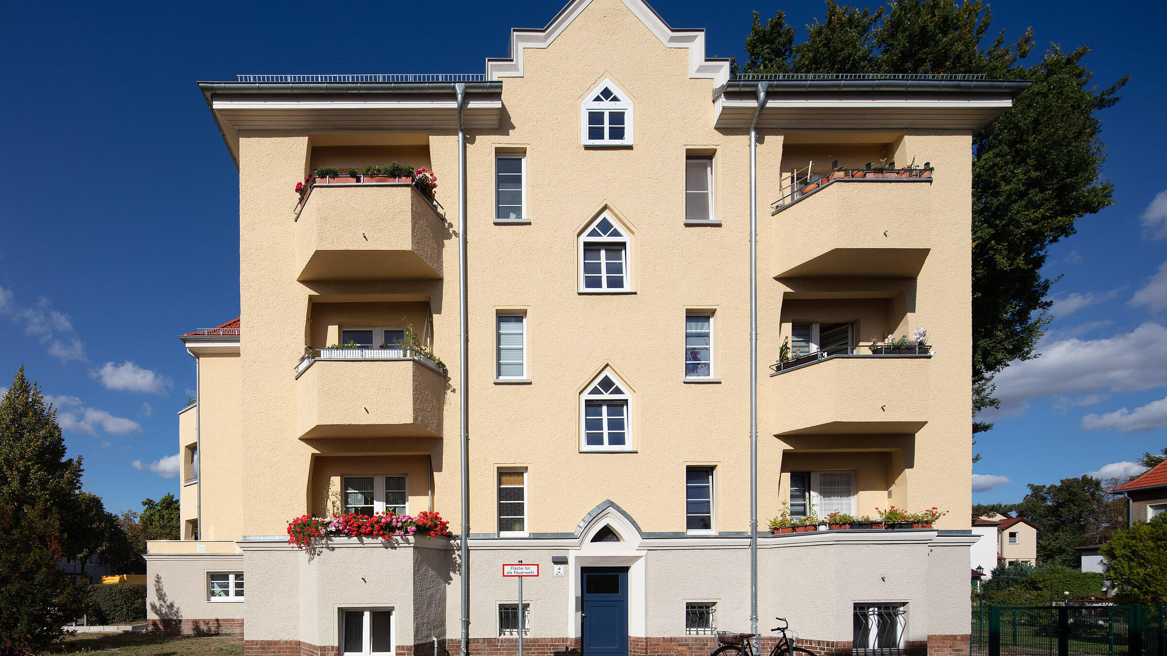 Außenaufnahme zeigt die frisch renovierte, hübsche Fassade eines 1929 gebauten Mehrfamilienhauses in der Romain-Rolland-Straße.