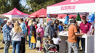 Außenaufnahme zeigt Besucher*innen am GESOBAU-Stand auf dem Begegnungsfest 2024.