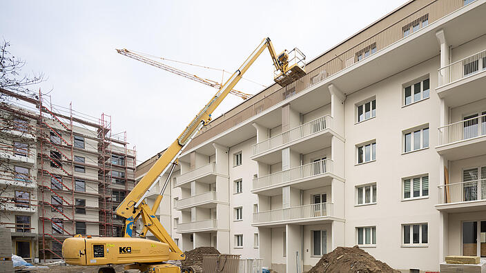 Außenaufnahme zeigt einen kleinen Kran vor dem frisch modernisierten Wohnhaus im Stiftsweg.