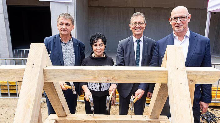 raditionelles Einschlagen der Nägel (v.l.n.r.) Jörg Winkler (Geschäftsführer DIW Bau GmbH), Emine Demirbüken-Wegner (Bezirksbürgermeisterin Reinickendorf), Christian Gaebler (Senator Stadtentwicklung, Bauen und Wohnen), Jörg Franzen (Vorstandsvorsitzender der GESOBAU AG).