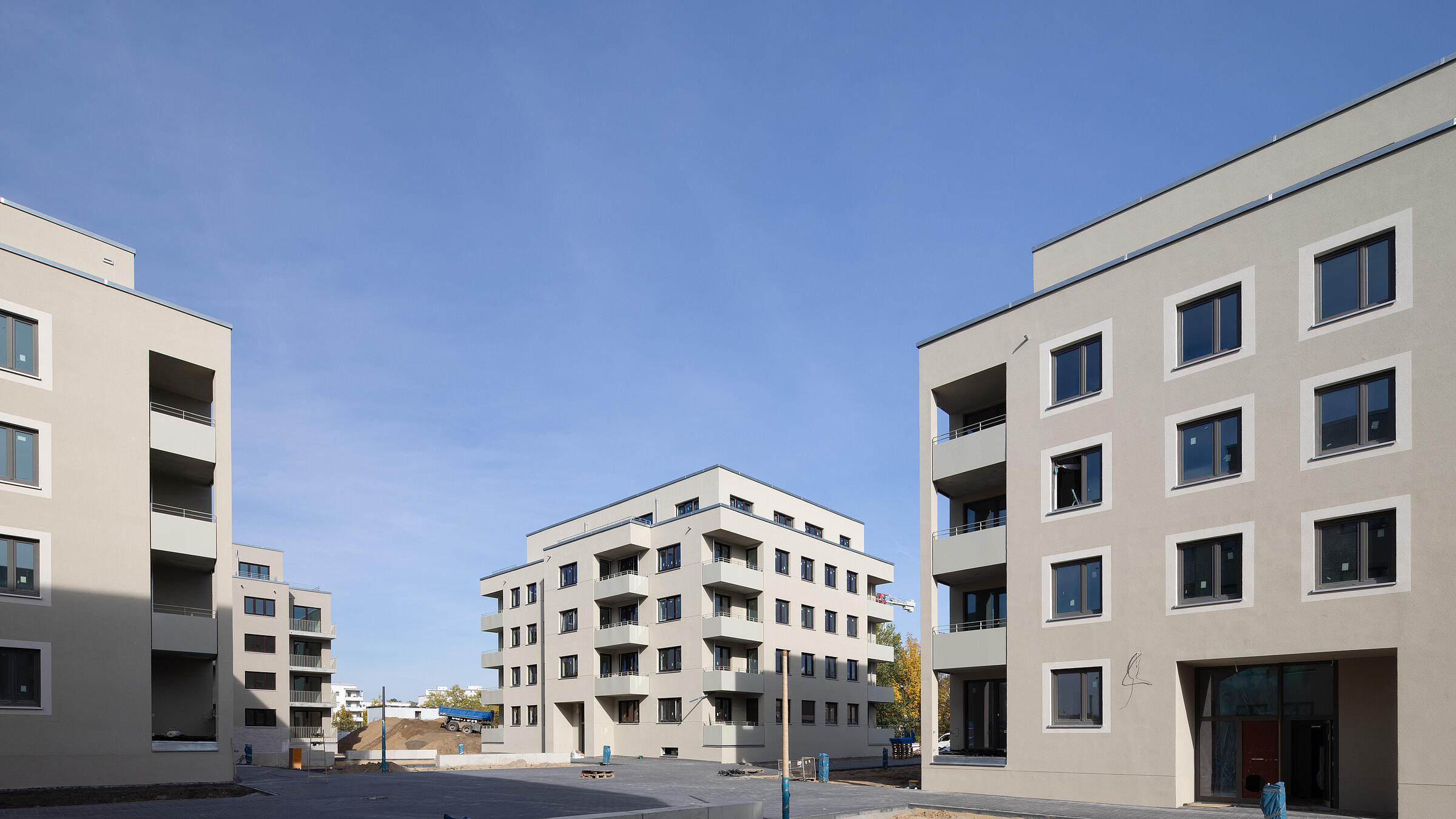 Blick in eine moderne freundliche Wohnanlage, die sich noch im Bau befindet