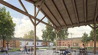 Der ehemalige Geräteschuppen wird Platz zum Verweilen bieten. Im Hintergrund zu sehen: eine denkmalgerecht sanierte Scheune (links) sowie der ehemalige Speicher (rechts) ergänzt um einen Neubau.